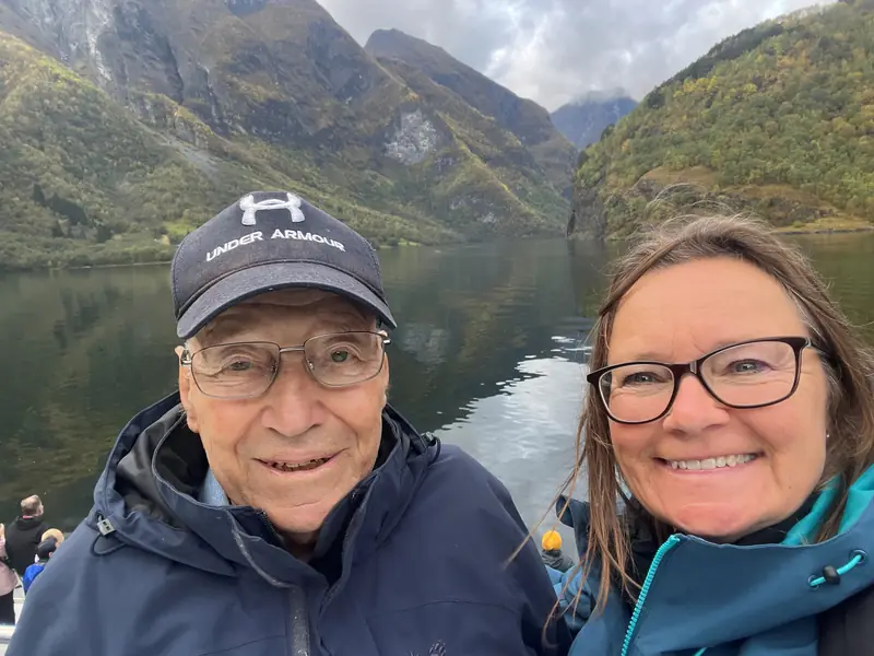 Philly and her dad on a boat on a Norwegian fjord