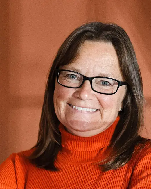 Philly smiling in an orange top